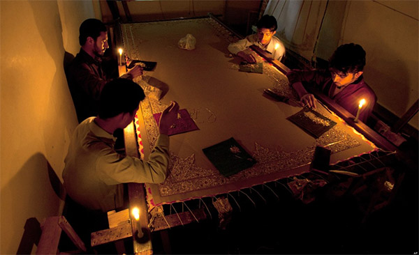 Workers Working in light of candle during power cut